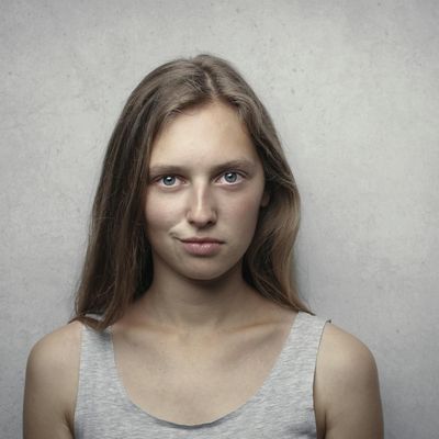 Headshot of a smiling woman with a neutral background.